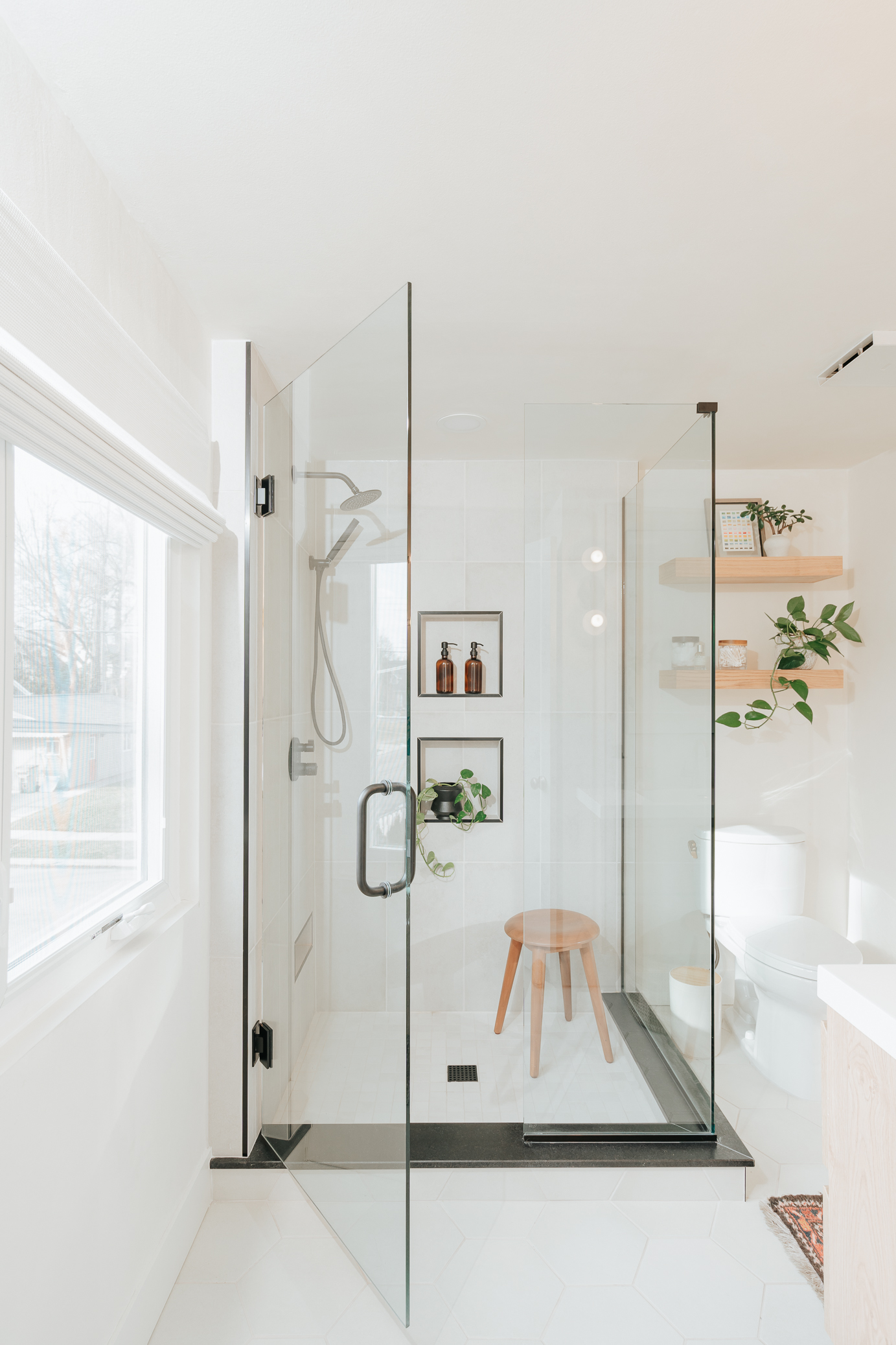 Image of a small bathroom remodel utilizing glass doors