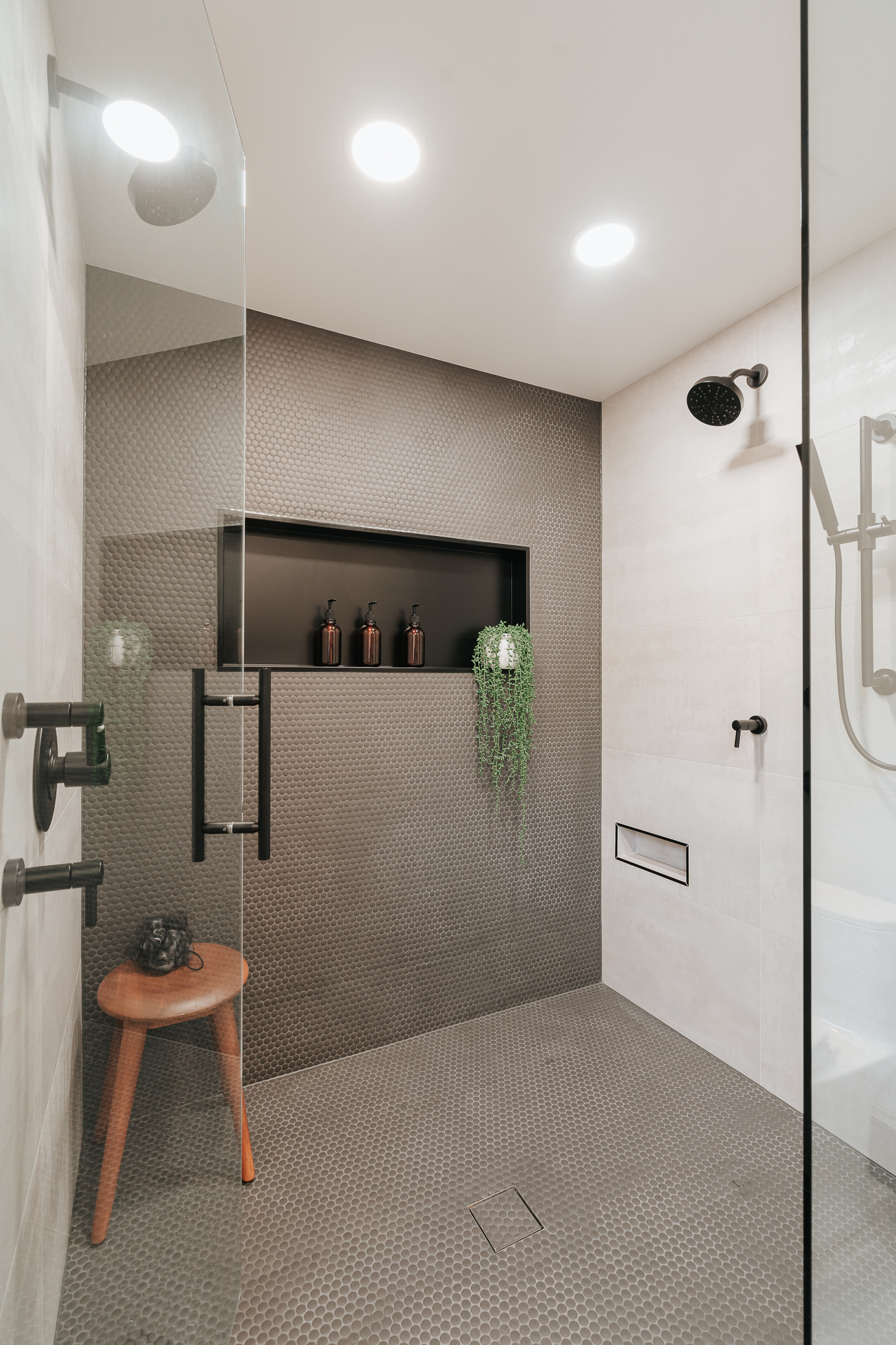 Image of a small bathroom remodel shower utilizing tile from ceiling to floor