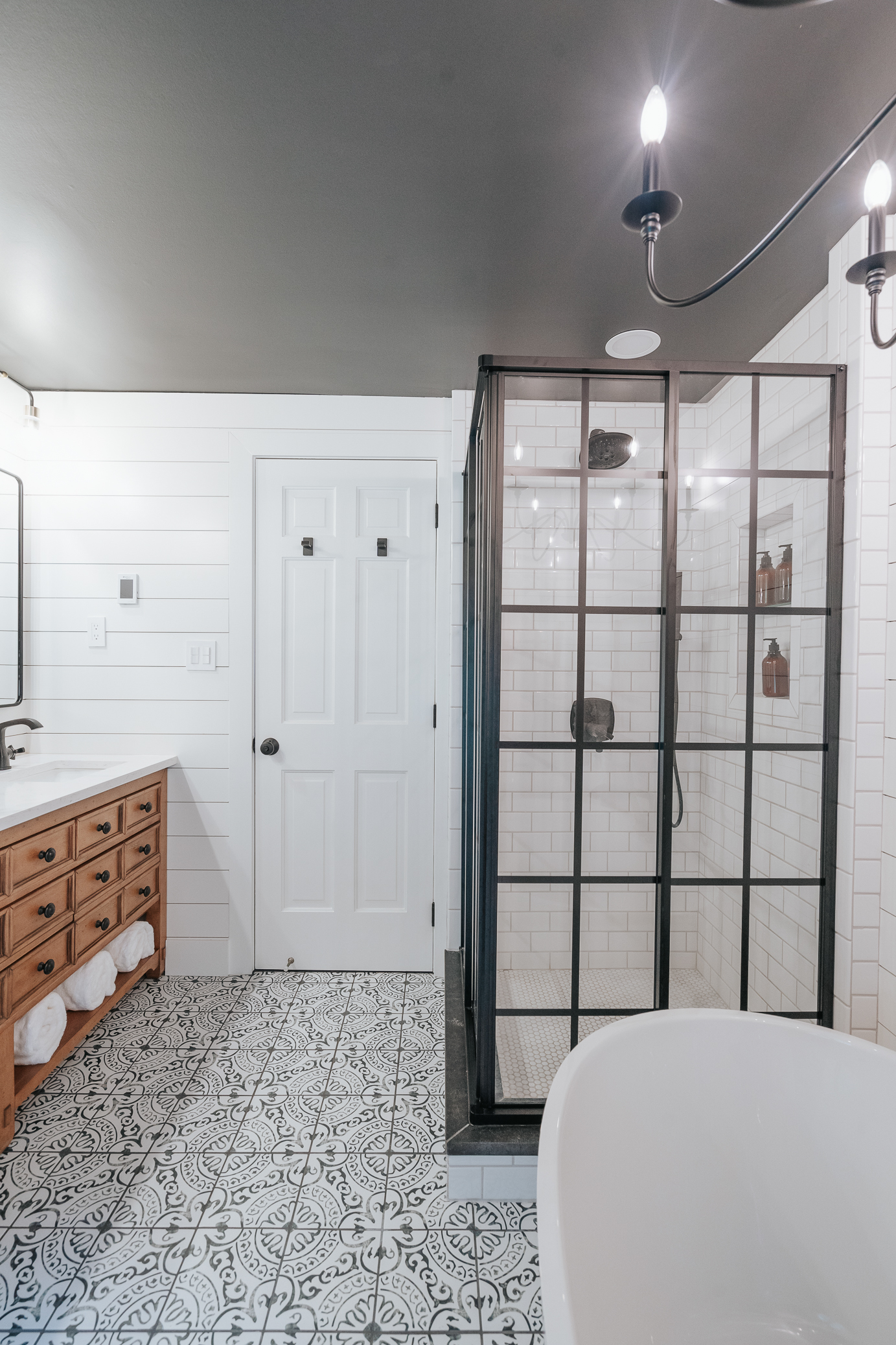 Image of a small bathroom remodel utilizing planned dark colors