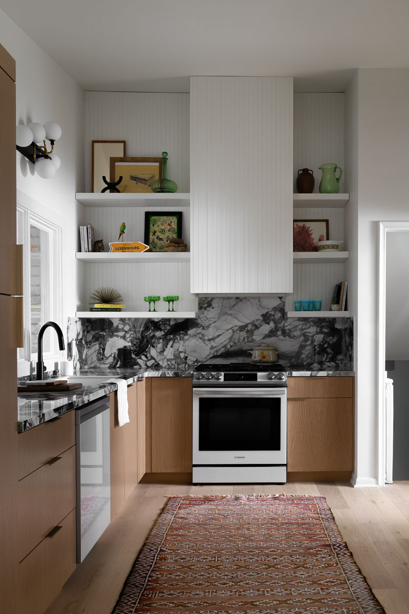 High-end kitchen in Royal Oak, MI, featuring brass hardware, custom backsplash, and white oak cabinetry.
