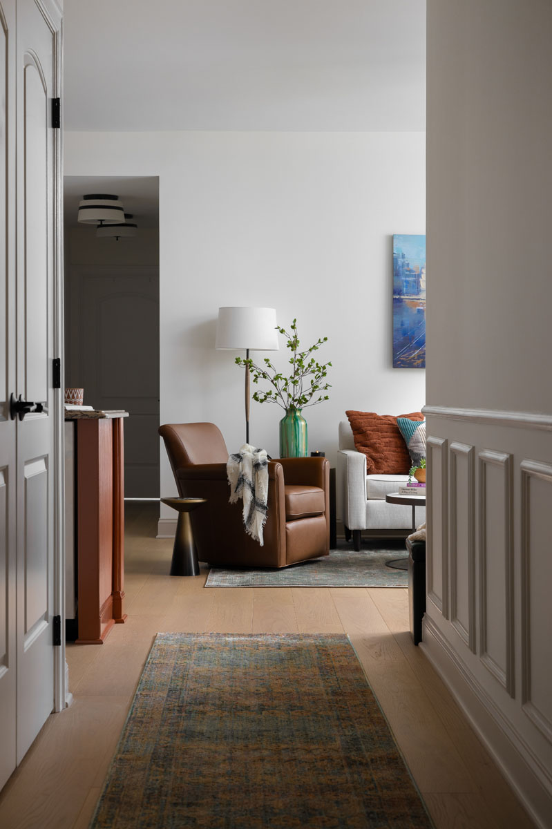 Custom entryway and living room in Ann Arbor, MI, featuring modern furniture, luxury decor, and elegant design.