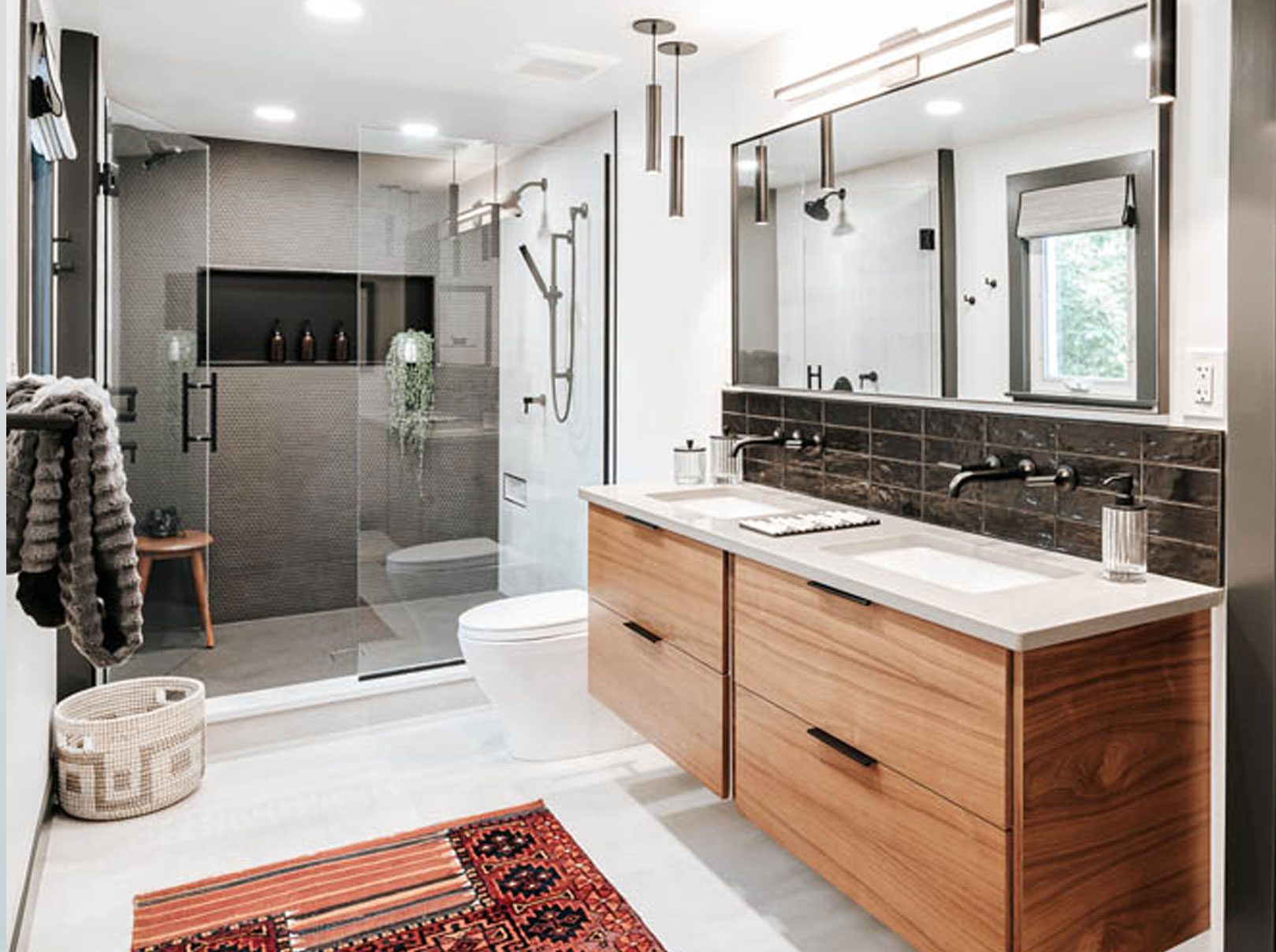 Custom bathroom remodel near me featuring a glass-enclosed shower, modern vanity, and marble accents by Clark + Aldine.