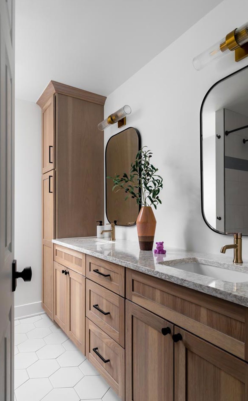Spa-like bathroom in Plymouth, Michigan, featuring a white oak double vanity, quartz countertop, and brass accents.