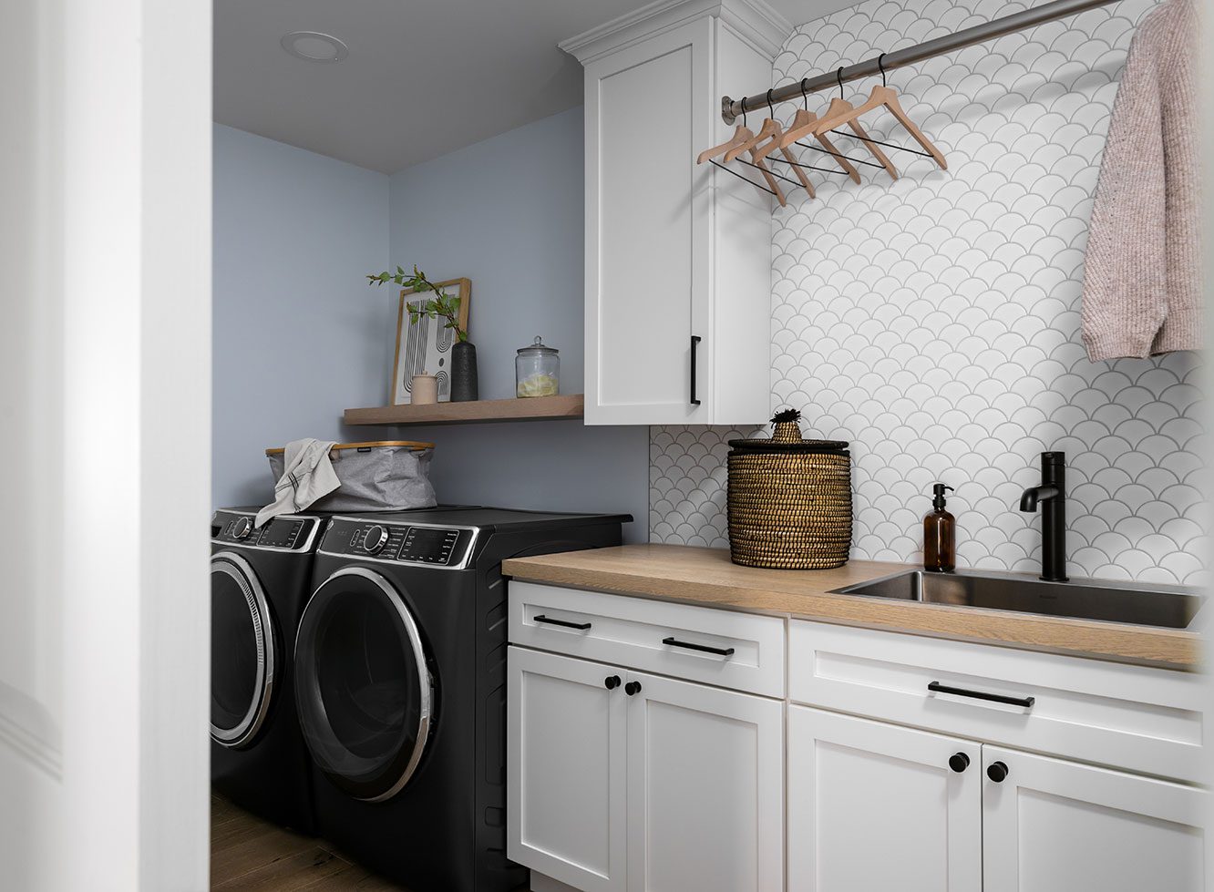 Construction and remodeling by Clark + Aldine – a completed modern laundry room designed with expert craftsmanship and functionality.