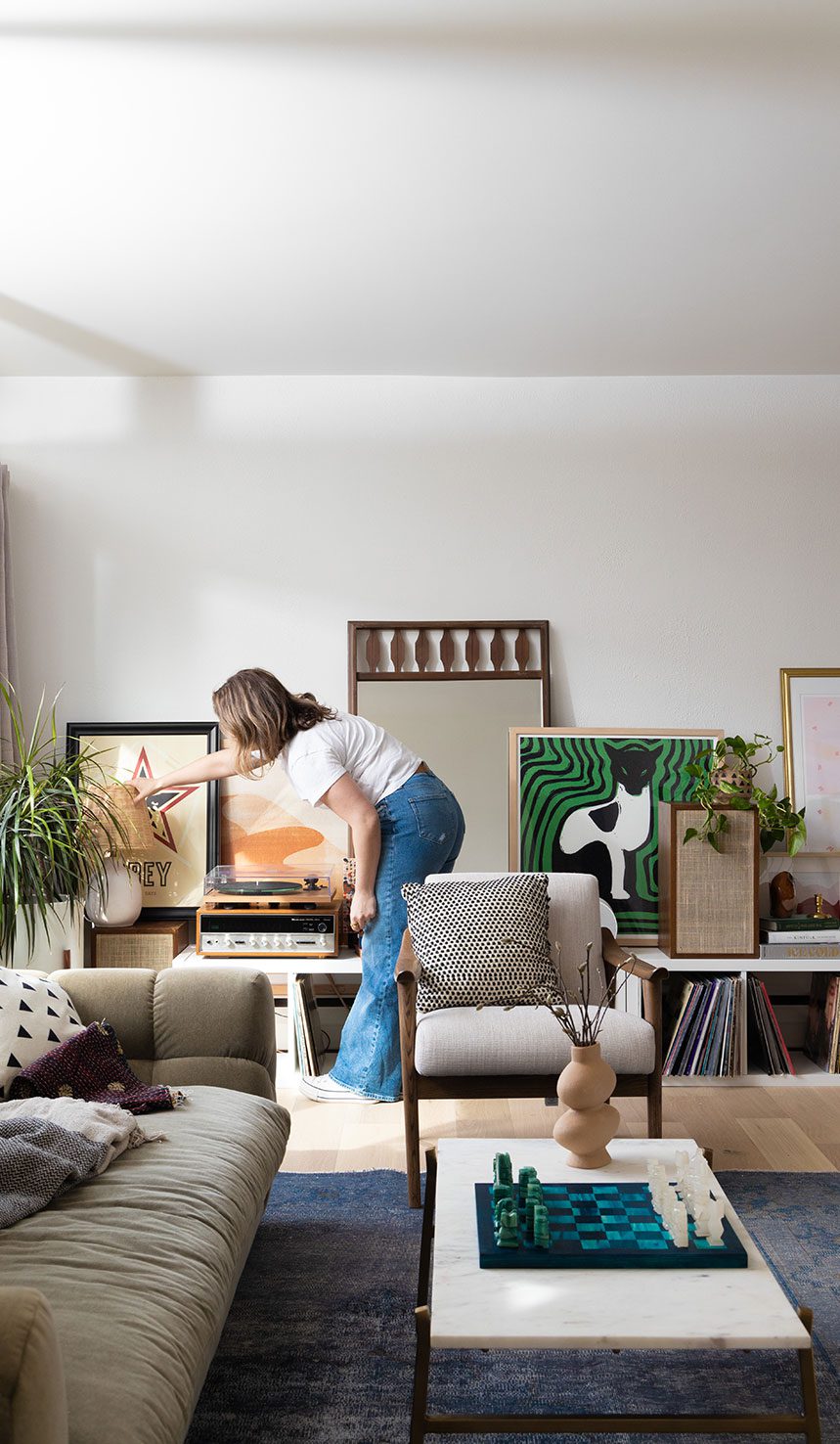 Clark + Aldine residential interior design – an interior designer placing a curated design element to finalize a thoughtfully sourced living space.