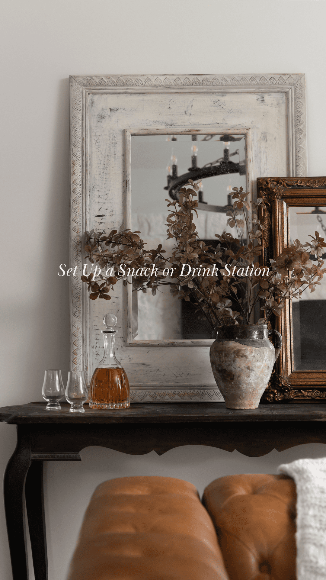 A cozy drink station setup featuring a rustic wooden table with glass decanter, glasses, and natural decor elements, perfect for holiday gatherings. The biophilic-inspired setting includes earthy tones and greenery for a warm, inviting atmosphere.