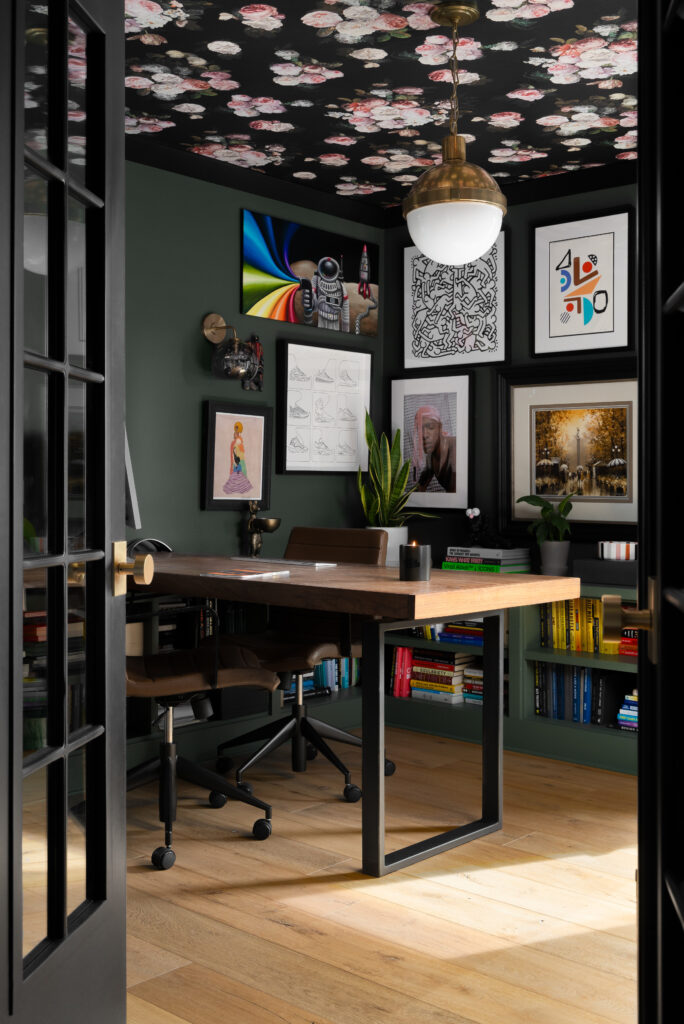 A stylish biophilic home office featuring natural materials, abundant natural light, indoor plants, and nature-inspired elements. The space includes a wooden desk, artistic wall decor, and a floral-patterned ceiling, promoting a productive and stress-free work environment.