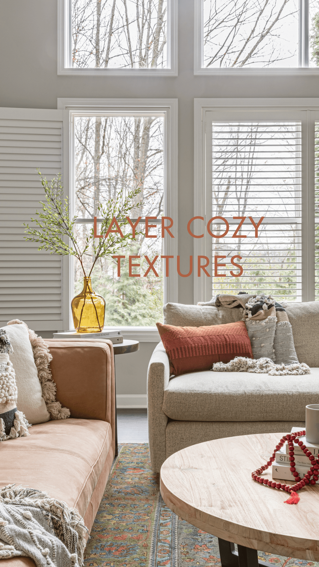 A biophilic living room with layered textures, including a soft area rug, warm throw pillows, and natural decor accents, designed for ultimate coziness.