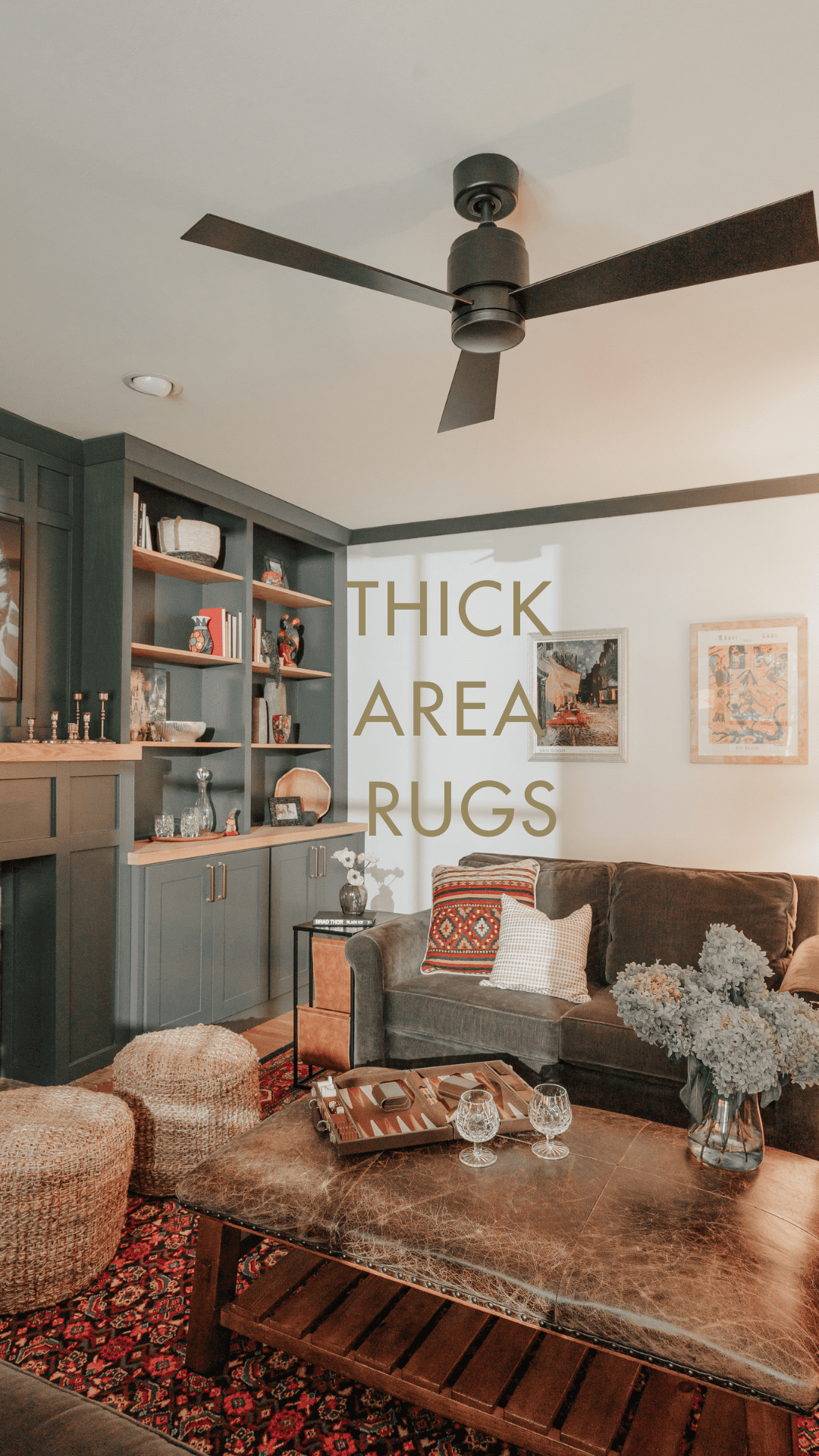A cozy living room with a thick patterned area rug, natural fiber poufs, and comfortable seating. The design emphasizes warmth and a biophilic aesthetic.