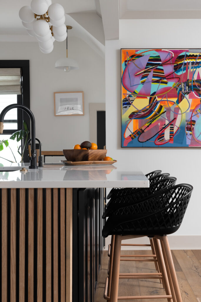 High-end kitchen featuring smart appliances, including a touchless faucet, built-in refrigerator, and Wi-Fi-enabled oven.