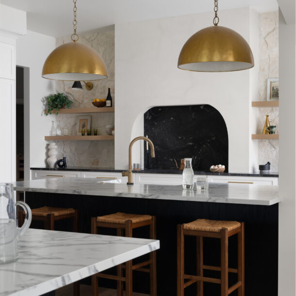 Luxury kitchen in Plymouth, MI, featuring marble countertops, white oak cabinetry, custom-built island, and brass hardware.