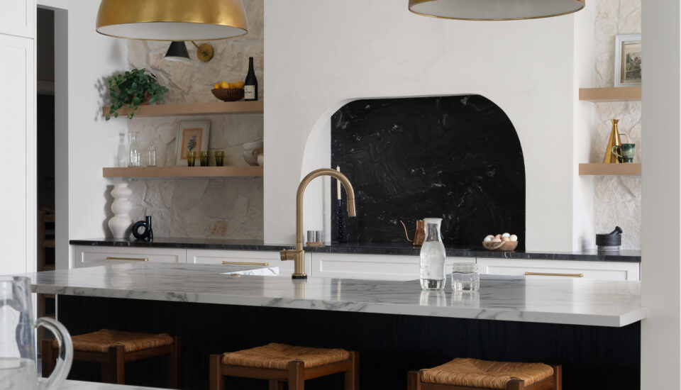 Luxury kitchen in Plymouth, MI, featuring marble countertops, white oak cabinetry, custom-built island, and brass hardware.