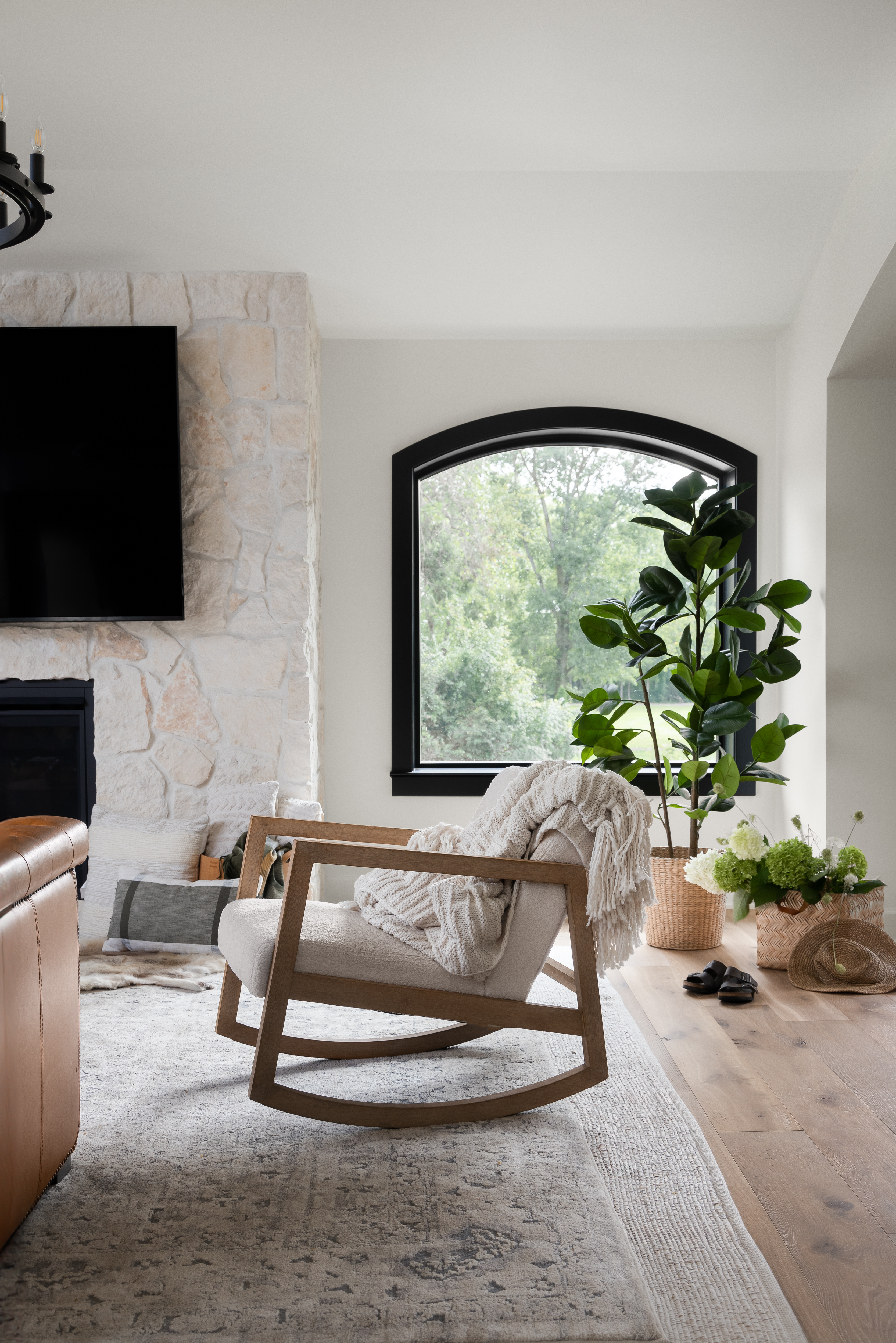 A sustainable living room featuring white oak flooring, eco-friendly furniture, and natural light.